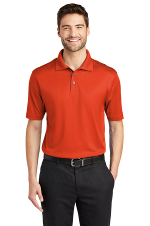 A man wearing a short-sleeved performance polo shirt with a collar, a 3-button placket, and black pants.