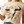 A woman wearing a beige t-shirt with a longhorn watercolor design, paired with blue jeans.
