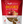 A package of Fruitables Biggies dog treats with a visible flower shape and ingredients like almond butter and coconut.