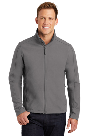 A man wearing a gray softshell jacket with a zip-through cadet collar, chin guard, and front zippered pockets.