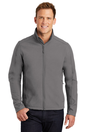 A man wearing a gray softshell jacket with a zip-through cadet collar, chin guard, and front zippered pockets.