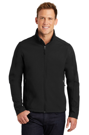 A man wearing a gray softshell jacket with a zip-through cadet collar, chin guard, and front zippered pockets.