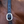 A brown leather horse halter with solid brass hardware, displayed on a horse.