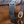 A black nylon cribbing strap with a metal buckle, fitted on a horse.