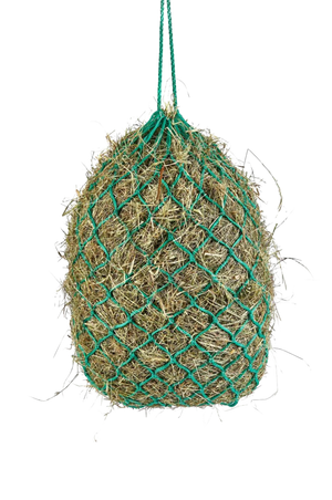 A green haylage net filled with hay.