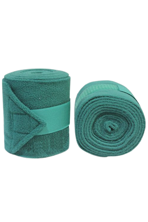 A pair of green Vac's Deluxe Polo bandages wrapped around a horse's forelimbs, showing the folded ends with hook and loop fasteners.