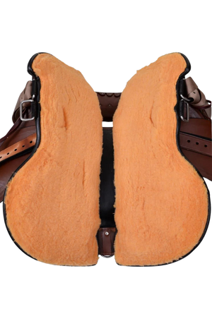 A brown Circle Y Brazos Wood Trail Saddle with a wooden tree and leather straps.