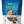 A package of Fruitables Biggies dog treats with a visible flower shape and ingredients like almond butter and coconut.