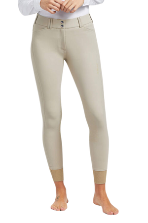 A pair of navy blue knee patch riding breeches with a white belt and white shirt, designed for equestrian activities.