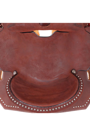A brown Circle Y Redwood Barrel Saddle featuring chestnut roughout leather, gunmetal conchos, and a hardseat.