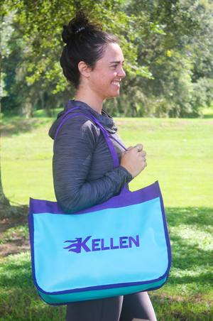 A red and blue paddock bag with a large yellow horseshoe logo on the front and purple straps.