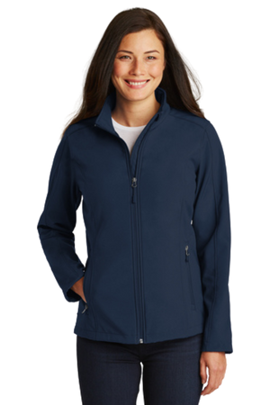 A woman wearing a navy softshell jacket with a zip-through cadet collar, chin guard, and front zippered pockets.