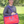 A red and blue paddock bag with a large yellow horseshoe logo on the front and purple straps.