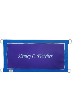 A custom stall guard with a solid blue background, white boarder and piping, displaying the text 'Henley C. Fletcher'.