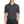 A man wearing a short-sleeved performance polo shirt with a collar, a 3-button placket, and black pants.