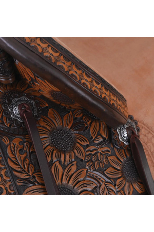 A brown western saddle with sunflower design and custom border tooling, including a matching flank cinch, made by Circle Y.