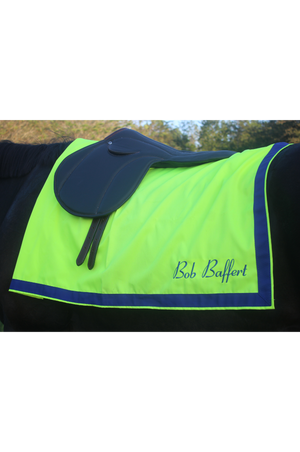 A custom saddle towel with blue, white, and pink colors, featuring embroidery on the sides.