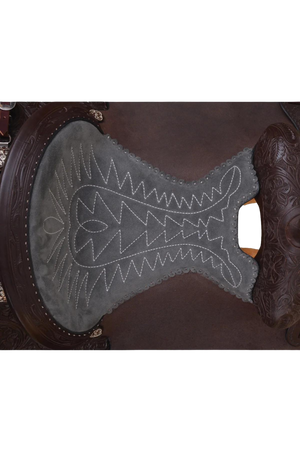 A brown Circle Y Mesquite Roper saddle with a horn on top and rigging straps, ready for use in rodeo or equestrian sports.