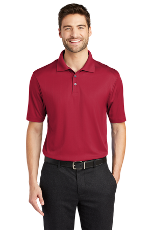 A man wearing a short-sleeved performance polo shirt with a collar, a 3-button placket, and black pants.