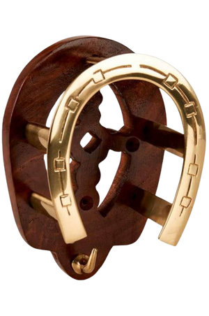 A golden horse shoe with a bridle bracket attached to it, displayed against a white background.