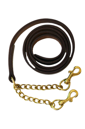 A brown leather horse show shank with brass hardware, coiled and laid out with a metal chain attached for bit attachment.