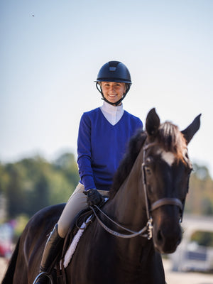 Woman riding a horse with a clear sky background