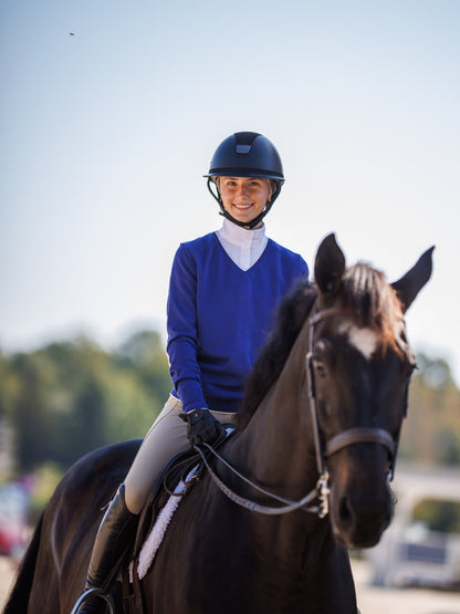 Woman riding a horse with a clear sky background