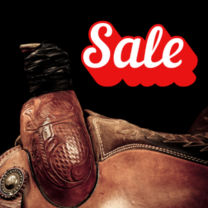 Brown leather saddle with intricate designs on a black background and red 'Sale' text.
