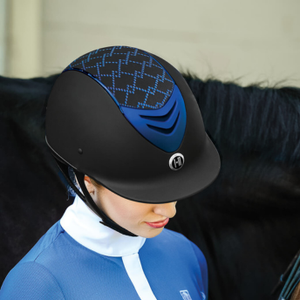 Person wearing a black and blue equestrian helmet with a blurred background