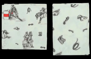 Two patterned napkins with cowboy and horse design on a light green background
