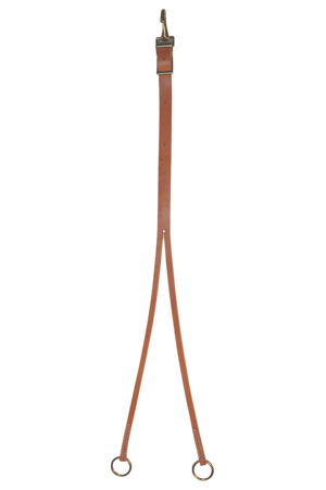Brown leather training fork with metal rings on a white background