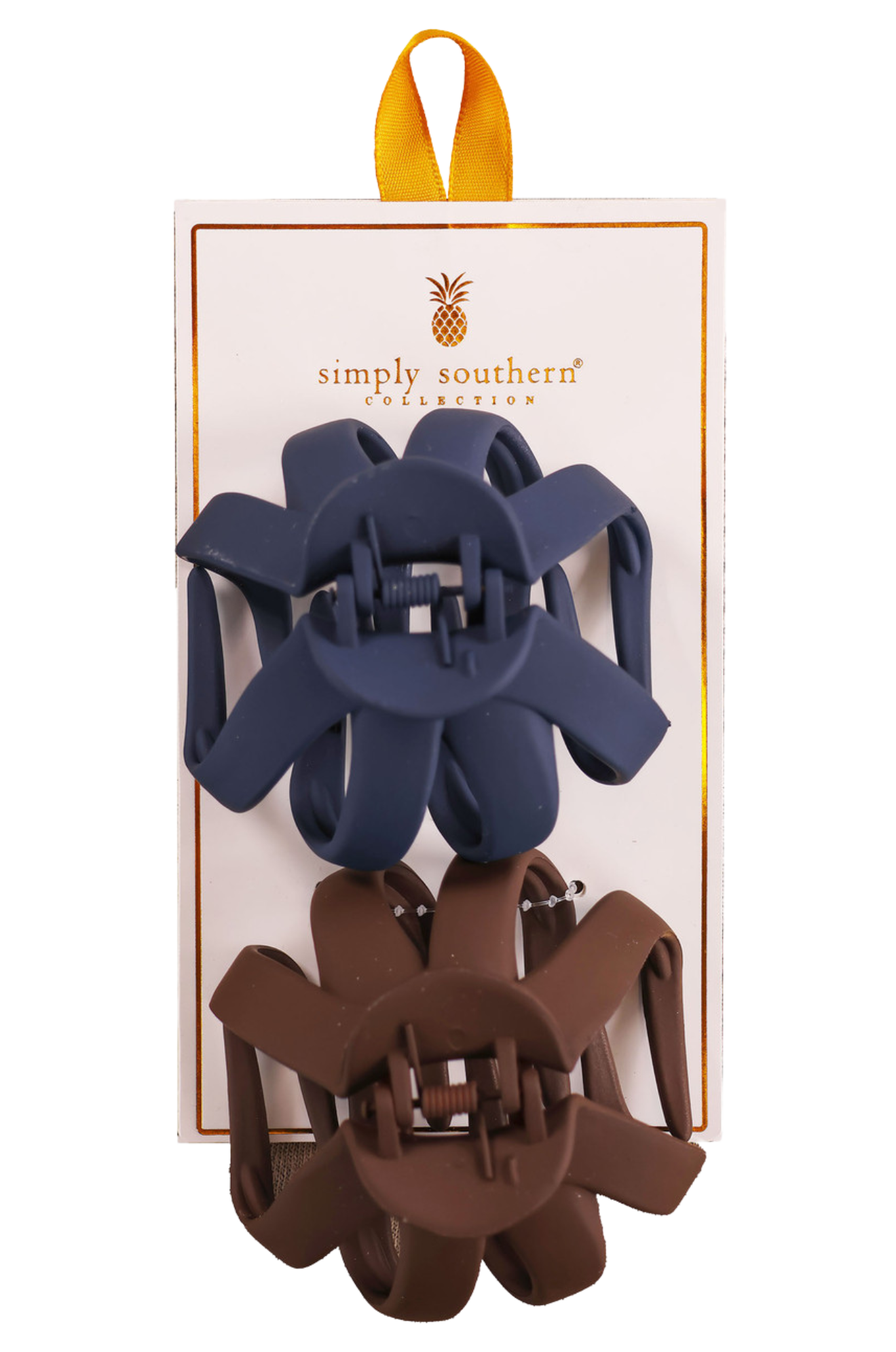 Two hair clips, one green and one brown, displayed on a vertical cardboard stand with a logo at the top.