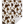 A sherpa throw with a cowhide print pattern in beige, brown, and white colors.