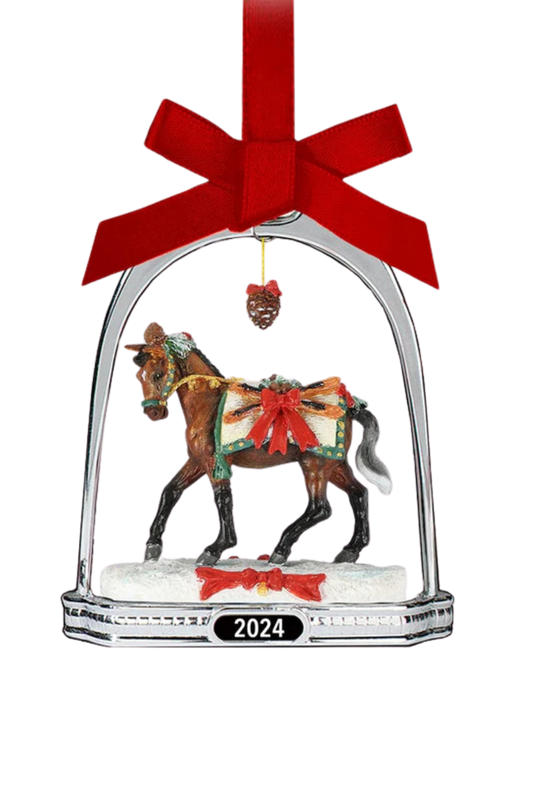 A holiday ornament featuring a miniature horse in a stirrup, with a pinecone and red ribbon.