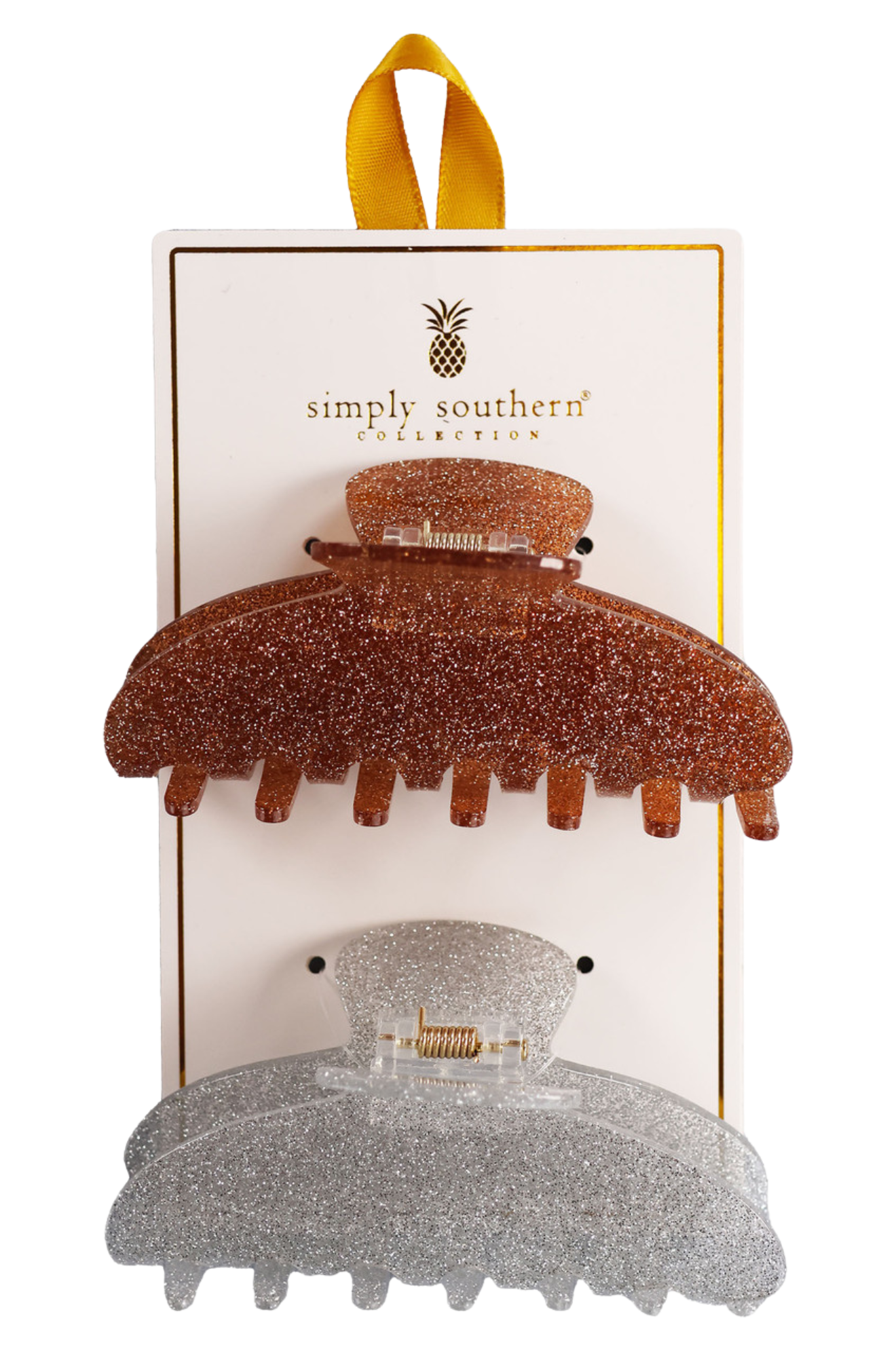 Two hair clips, one green and one brown, displayed on a vertical cardboard stand with a logo at the top.