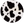 Round object with black and white cow print pattern on a white background