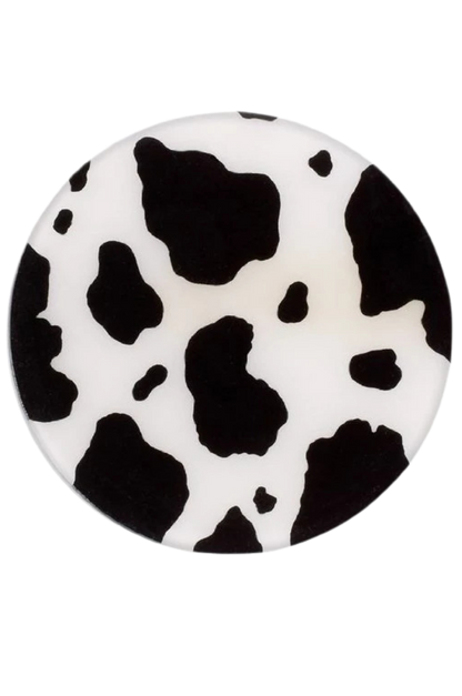Round object with black and white cow print pattern on a white background