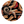 Circular design featuring cowboy boots, spurs, and lassos on a black background