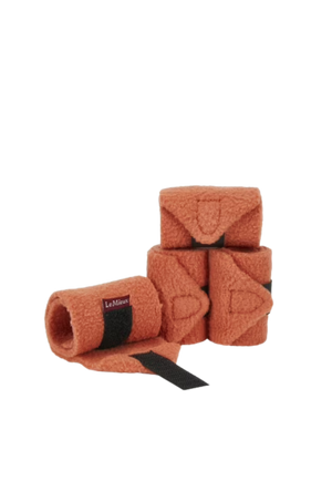 Set of brown horse leg wraps with black straps on a white background