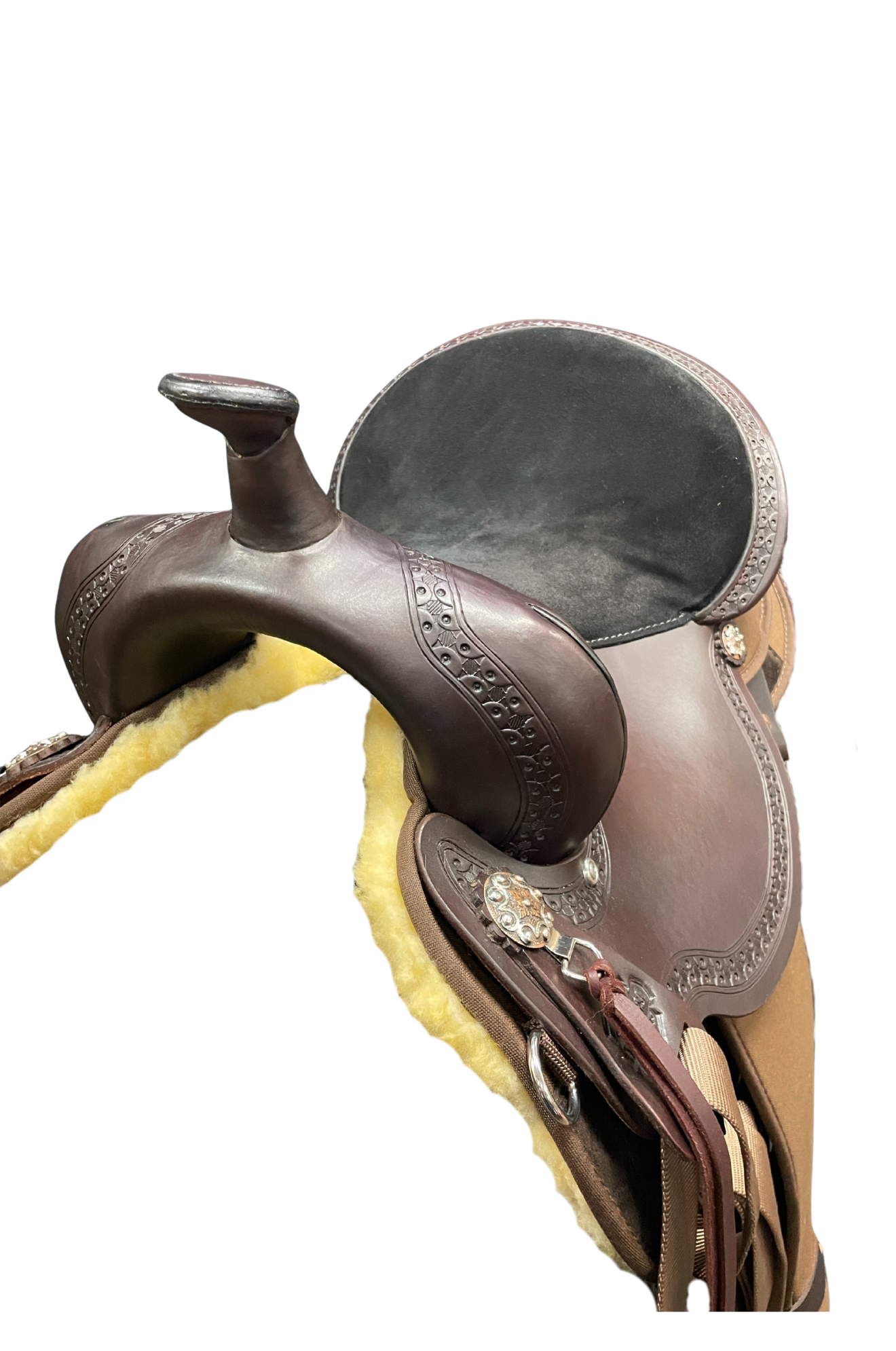 Close-up of a brown leather saddle with decorative elements on a white background