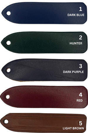A custom leather key chain with a brass engraved plate, showing the store name and logo.