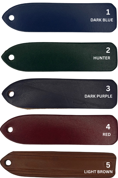 A custom leather key chain with a brass engraved plate, showing the store name and logo.