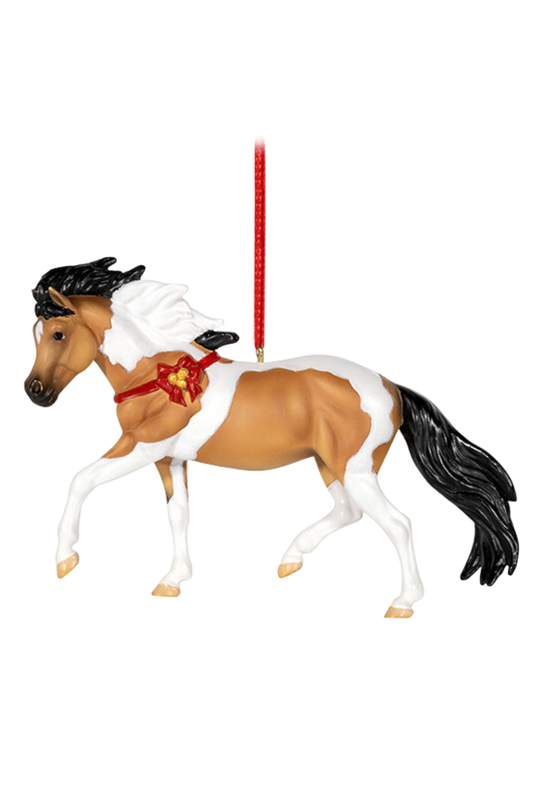 Horse figurine with a decorative saddle on a white background
