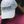 Person wearing a white cap with 'Tack Shack of Ocala' logo, blurred background