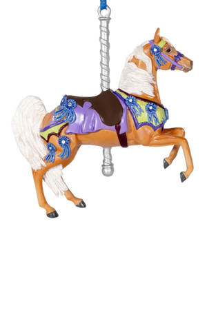 Decorative horse ornament with colorful saddle and blue accents on a white background