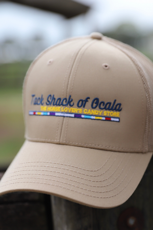 Beige cap with 'Tack Shack of Ocala' branding on a blurred background