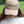 Person wearing a beige cap and white shirt with 'Tack Shack of Ocala' branding outdoors.