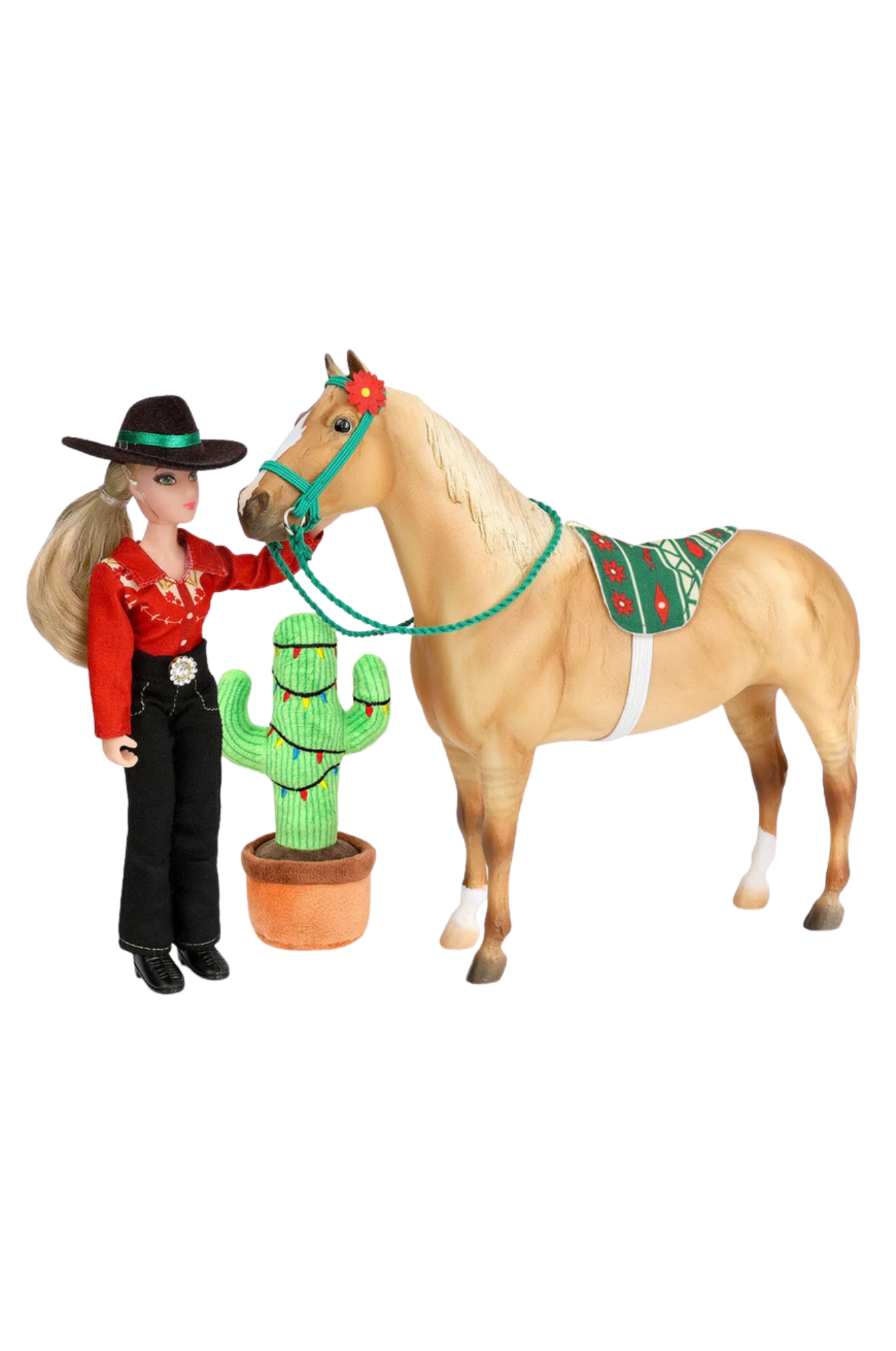 Barbie doll in cowboy outfit with horse and cactus toy on white background