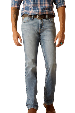 Person wearing light blue jeans and a plaid shirt on a white background