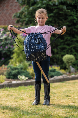 Girl holding a drawstring bag with star pattern outdoors